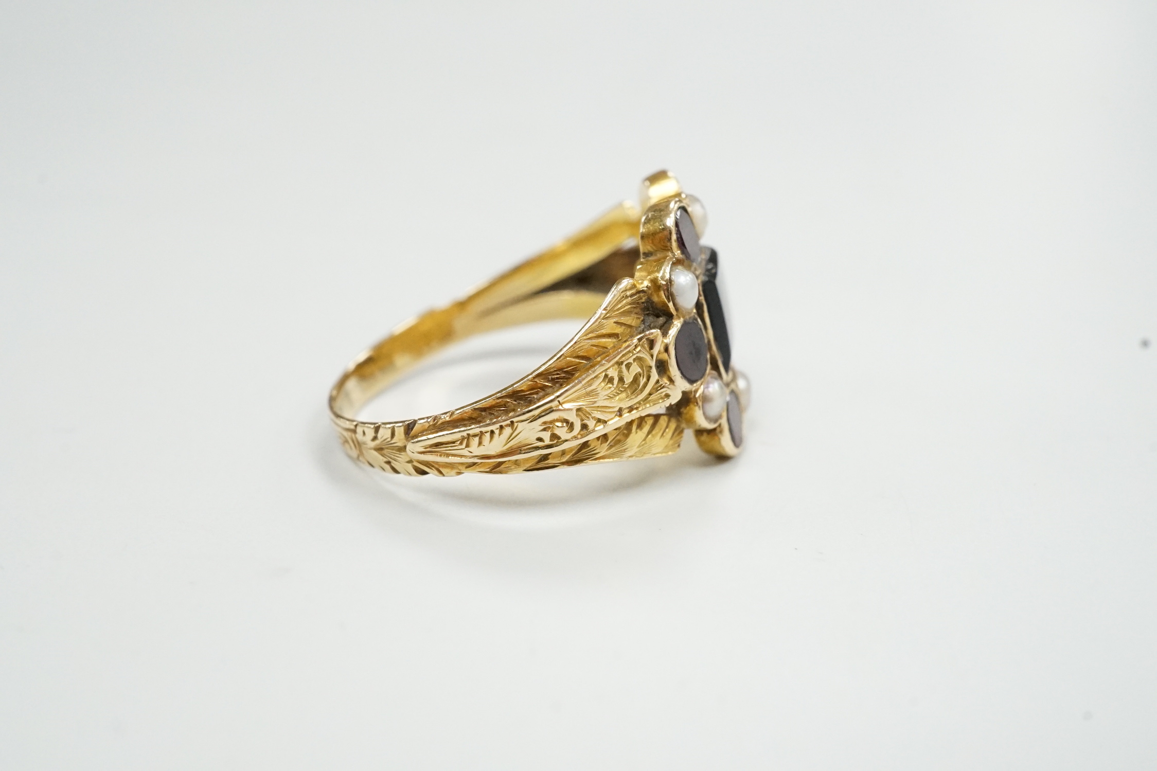 A George yellow metal, garnet and seed pearl cluster set mourning ring, with inscription dated 1799, size L, gross weight 2.7 grams.